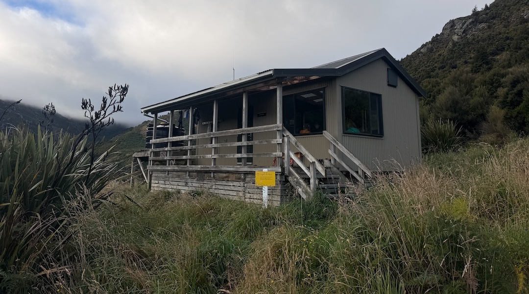 You have to climb up from the river for a few minutes. | Jubilee Hut, Silverpeaks Scenic Reserve