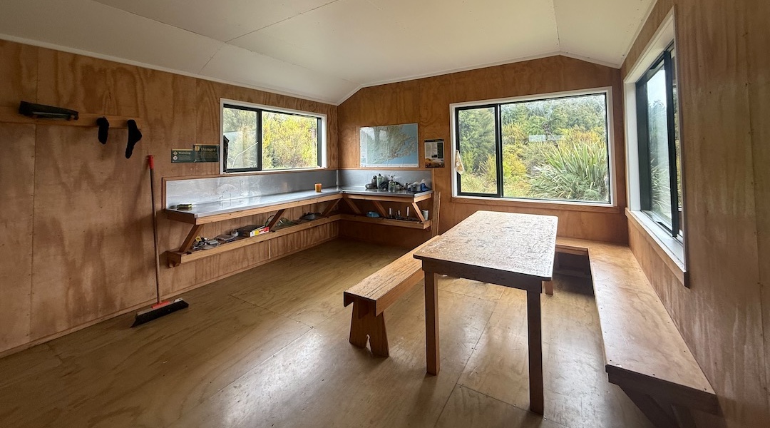 It's a spacious interior for ten with seating for all. | Jubilee Hut, Silverpeaks Scenic Reserve