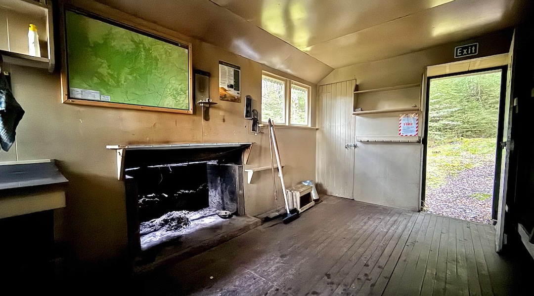 Has an open fire and, at the time, three brooms. | Cromel Base Hut, Eyre Mountains/Taka Rā Haka Conservation Park