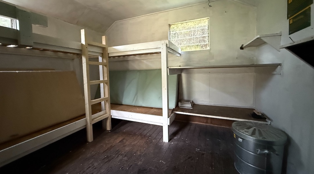 Interior with bunks and bench. | Cromel Branch Hut, Eyre Mountains/Taka Rā Haka Conservation Park